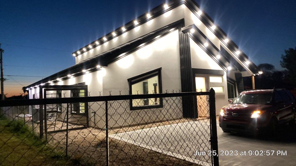 Modern house painted at dusk with decorative lighting